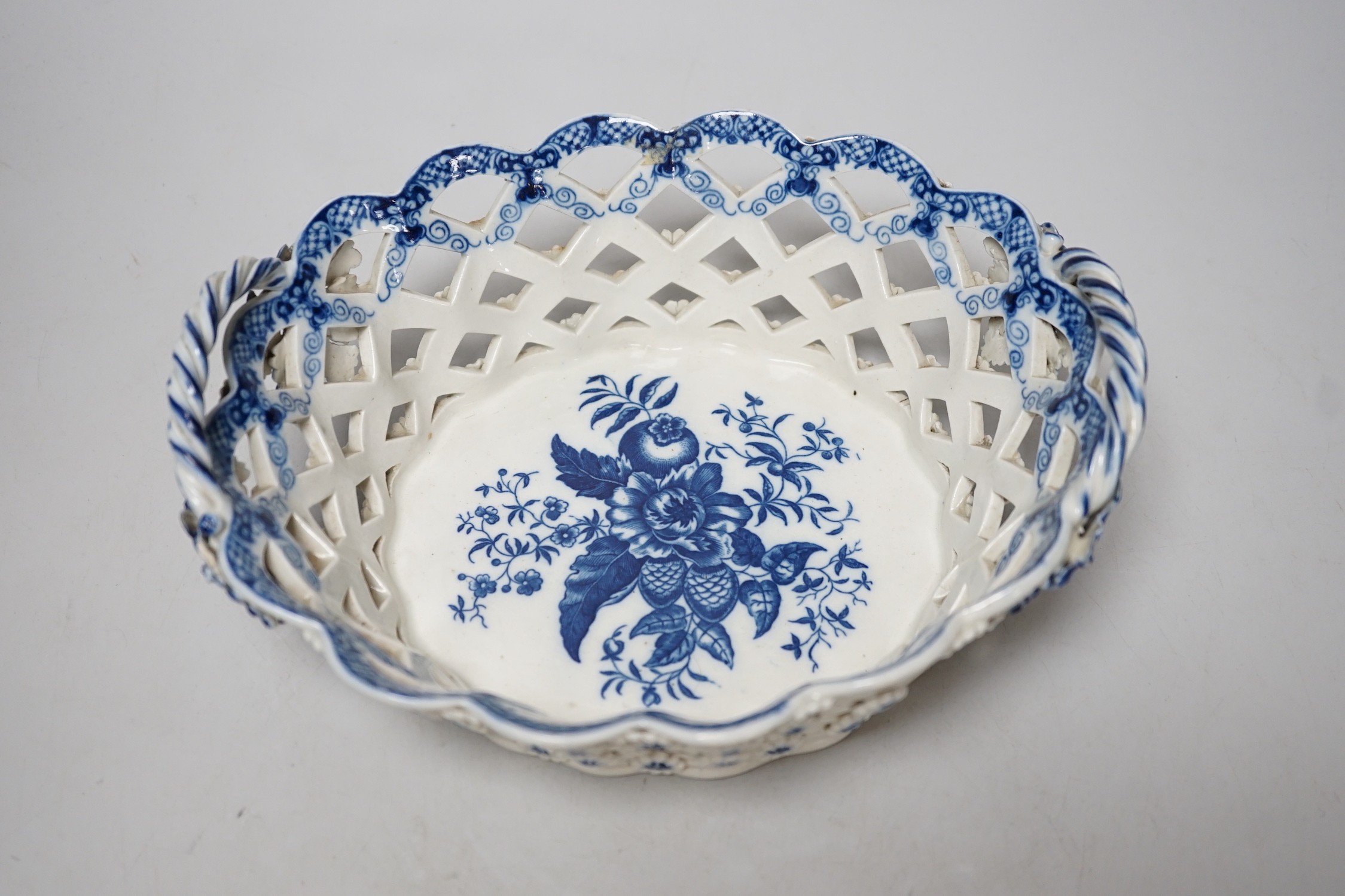 An 18th century Caughley basket printed with fir cones, under a painted border, C mark and very rare IT moulded mark, verso, Ex-Godden Reference Collection, 22cms wide